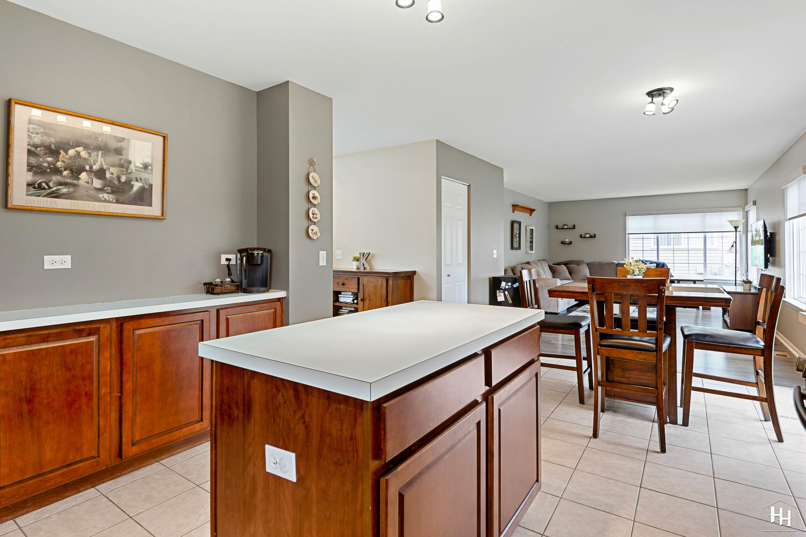 1389 Collins Drive Cary, IL 60013 - Photo 13 of 39 a open kitchen with stainless steel appliances a table chairs and a refrigerator