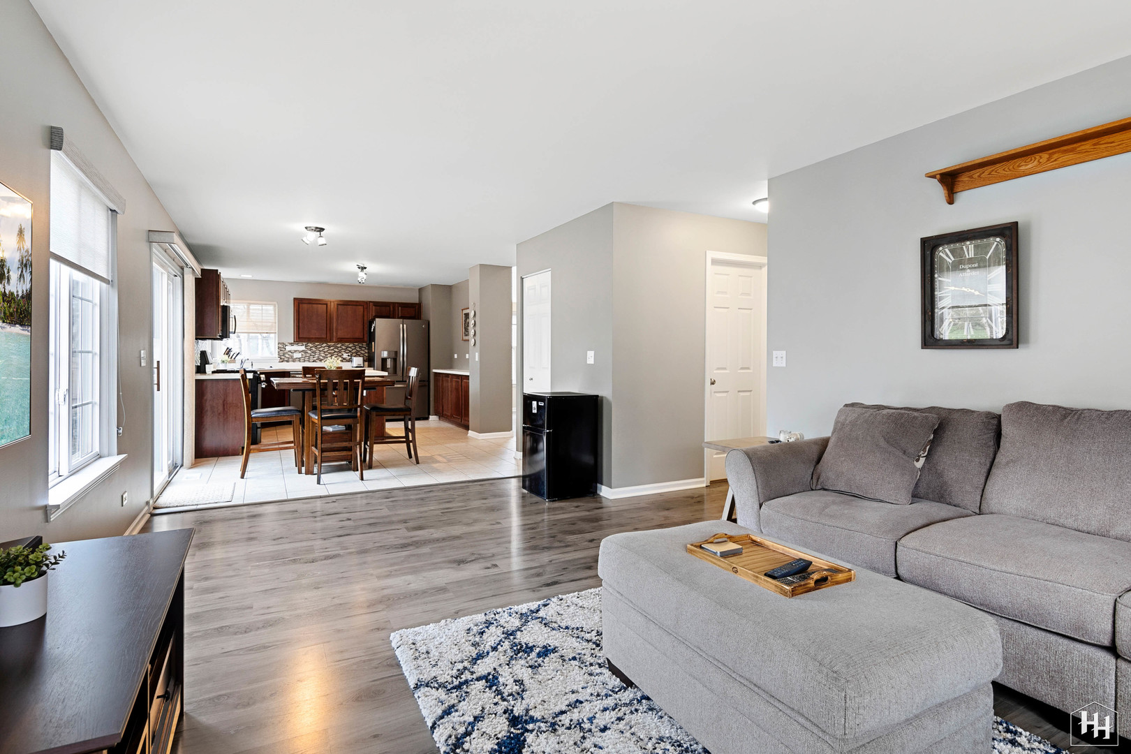 1389 Collins Drive Cary, IL 60013 - Photo 16 of 39 a living room with furniture and a table with wooden floor