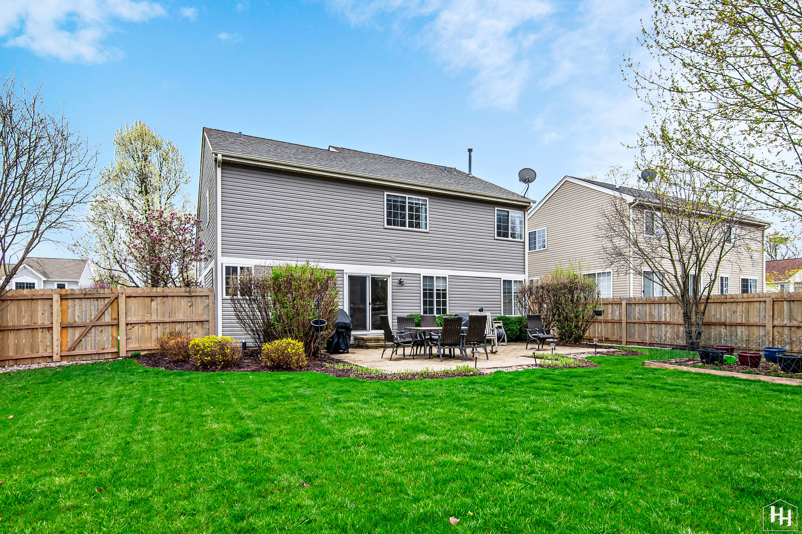 1389 Collins Drive Cary, IL 60013 - Photo 32 of 39 a view of a house with a yard fire pit and a large tree