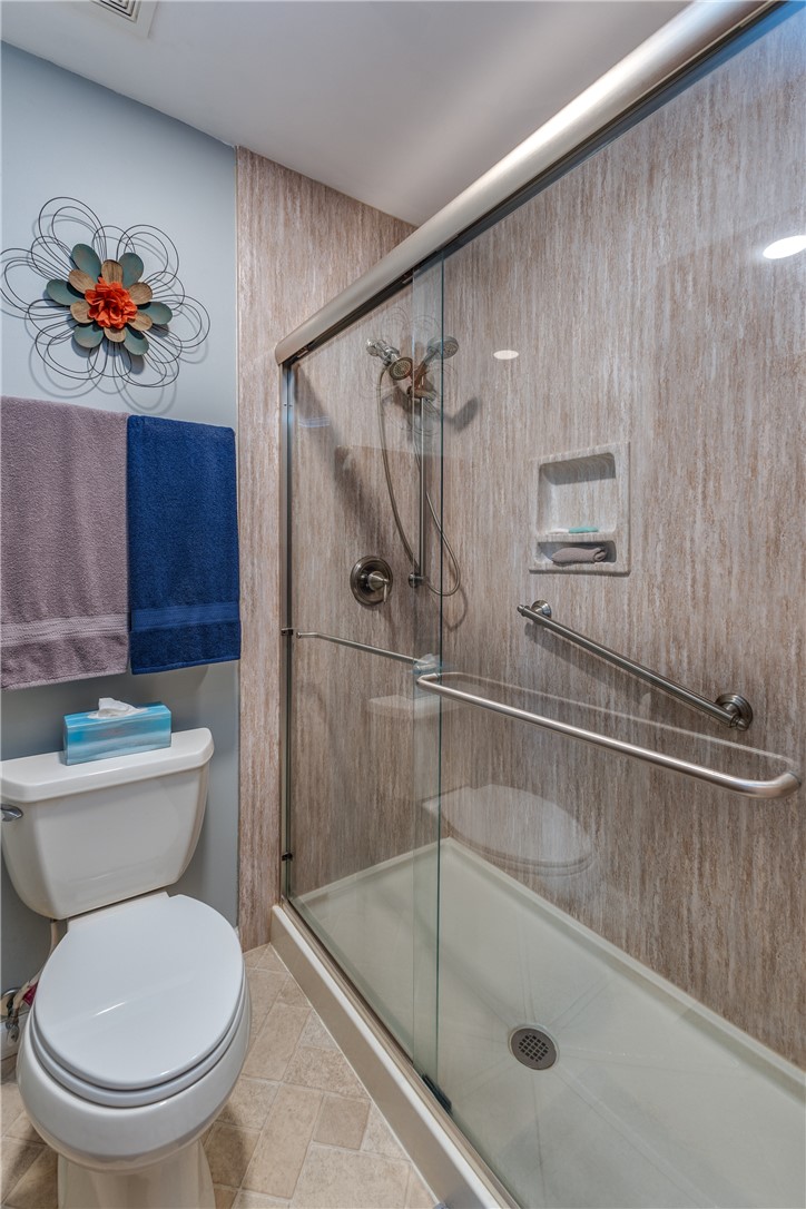 4210 Pleasanton Road Englewood, OH 45322 - Photo 21 of 34 This bathroom features a contemporary shower with grab bars for convenience and safety.