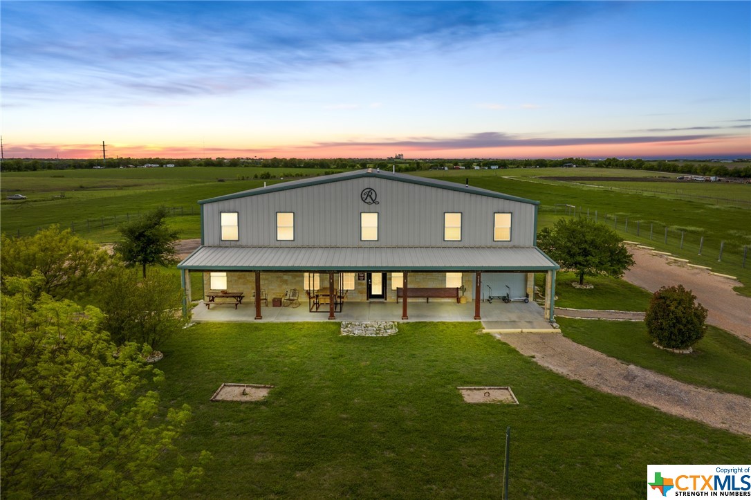 a view of a big house with a big yard
