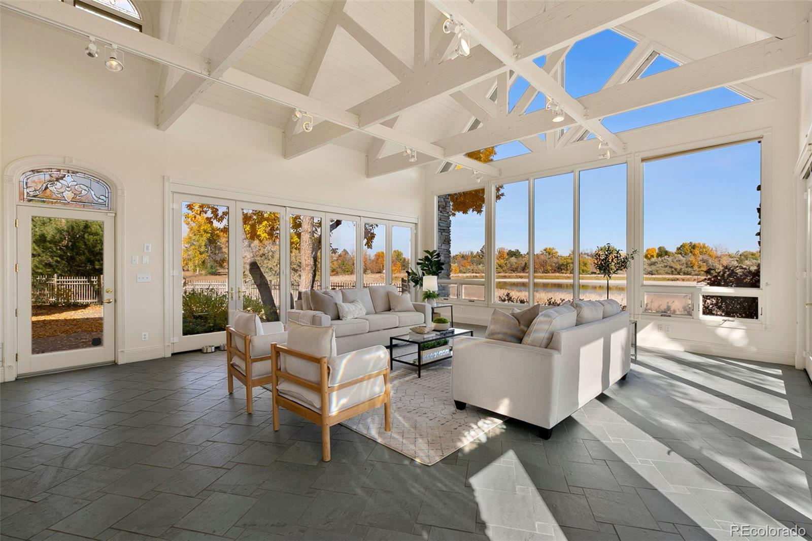 2400 Terry Lake Road Fort Collins, CO 80524 - Photo 13 of 44 a living room with fireplace furniture and a large window