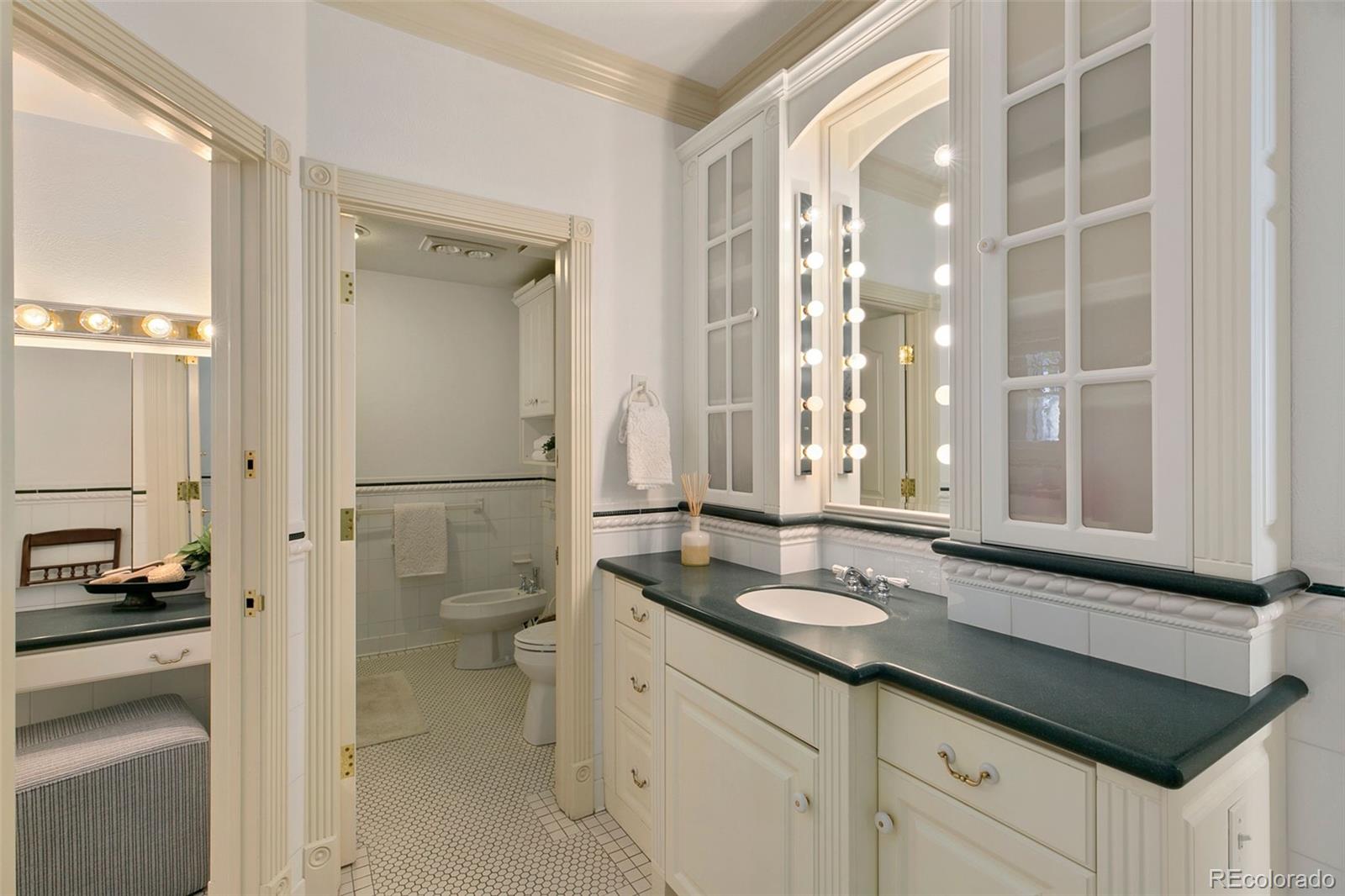 2400 Terry Lake Road Fort Collins, CO 80524 - Photo 19 of 44 a bathroom with a granite countertop sink mirror and a toilet