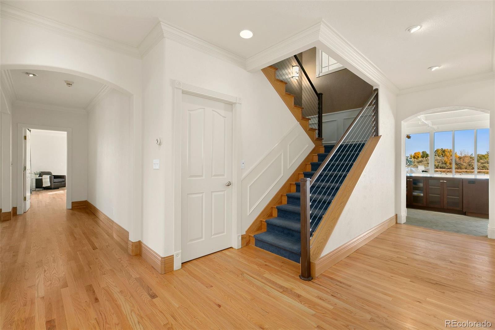 2400 Terry Lake Road Fort Collins, CO 80524 - Photo 21 of 44 a view of a hallway with wooden floor and staircase