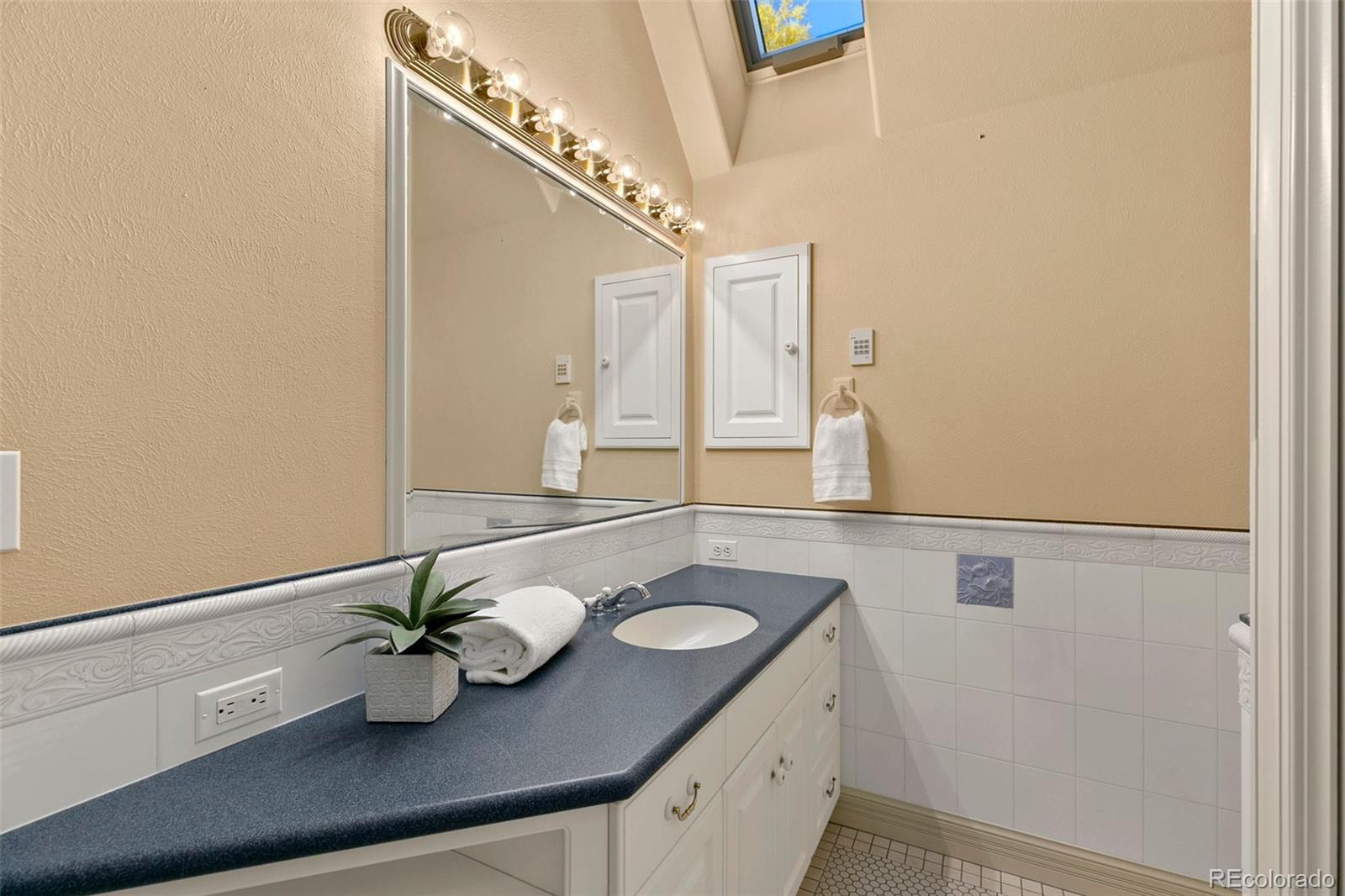 2400 Terry Lake Road Fort Collins, CO 80524 - Photo 24 of 44 a bathroom with a sink and a mirror