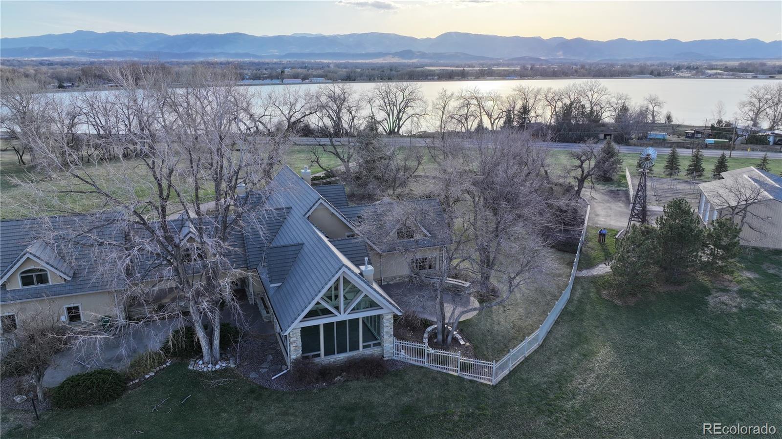 2400 Terry Lake Road Fort Collins, CO 80524 - Photo 39 of 44 a view of a house with a yard and a mountain view