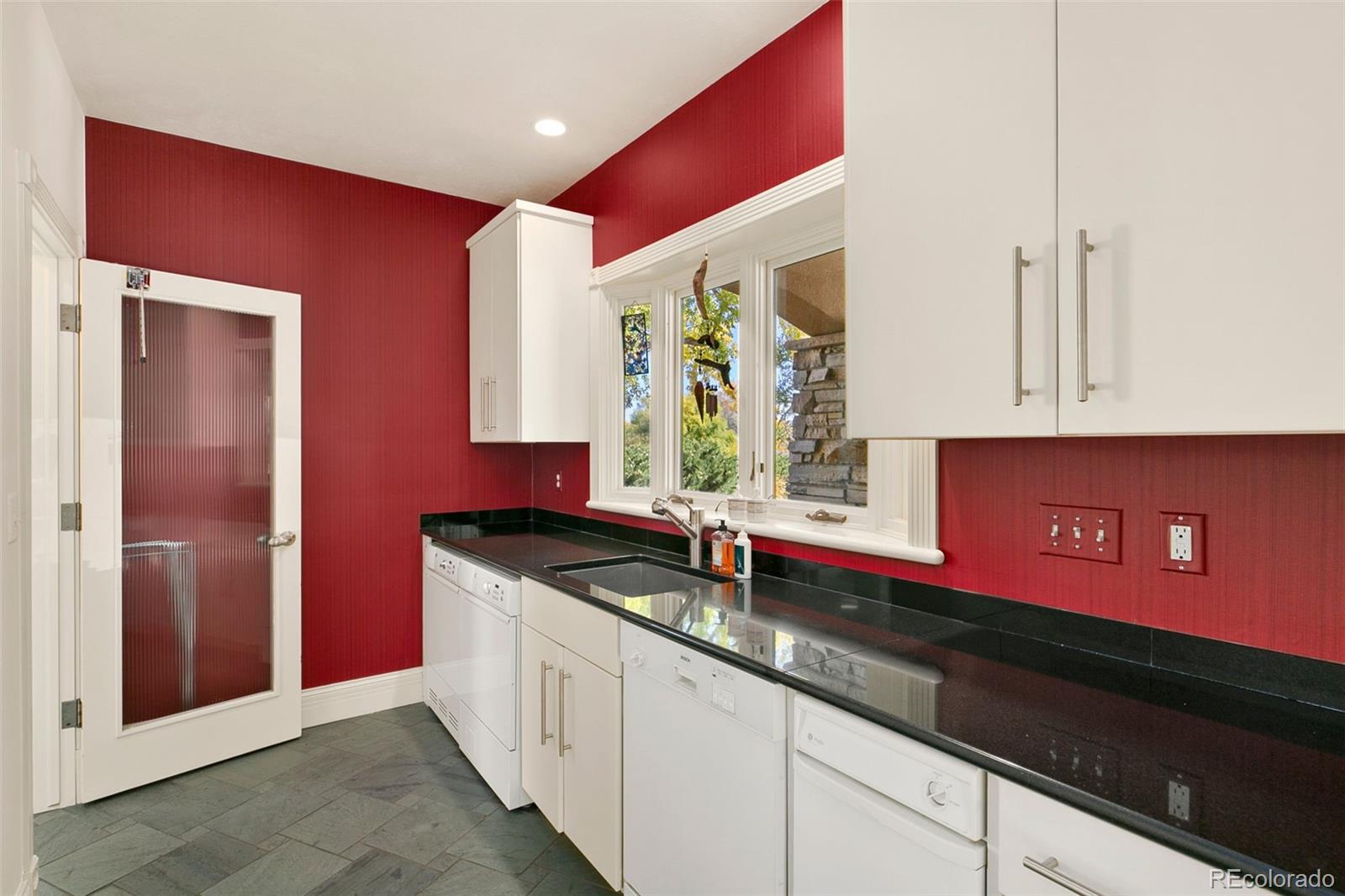 2400 Terry Lake Road Fort Collins, CO 80524 - Photo 8 of 44 a kitchen with granite countertop a sink and a counter space