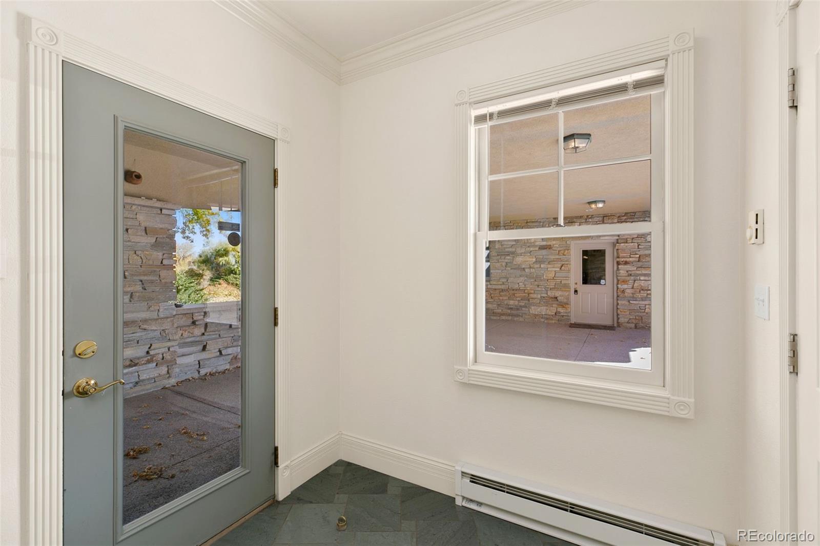 2400 Terry Lake Road Fort Collins, CO 80524 - Photo 9 of 44 a small space with a wooden door and a window