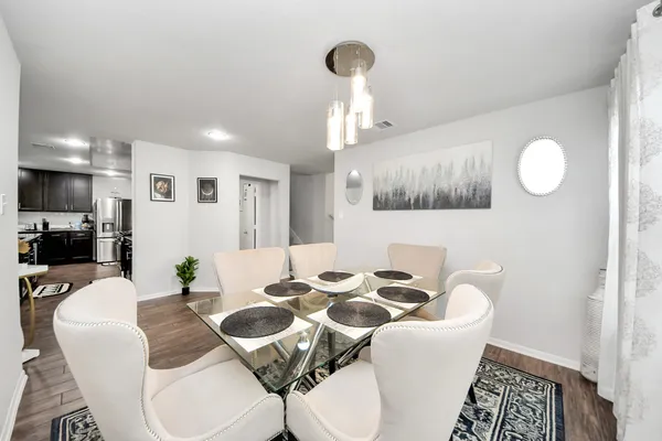 a view of a dining room with furniture and chandelier