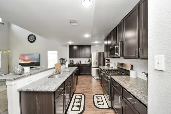 a dining room with furniture and a chandelier