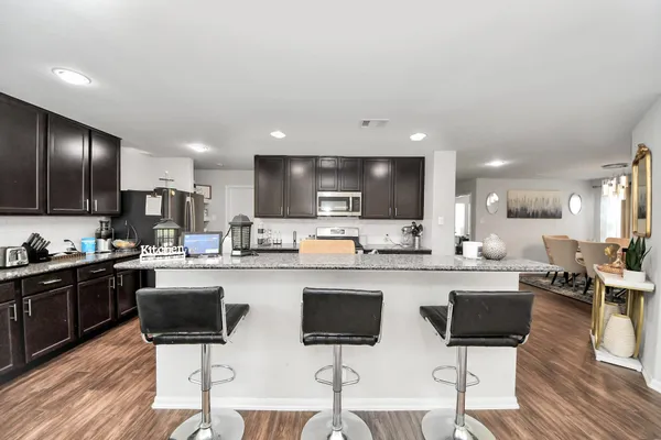 a kitchen with stainless steel appliances kitchen island granite countertop a sink and cabinets