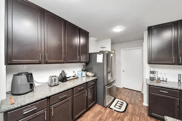 a kitchen with a sink and chairs