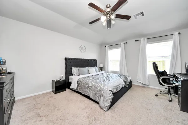 a living room with furniture a rug potted plant and a view of kitchen