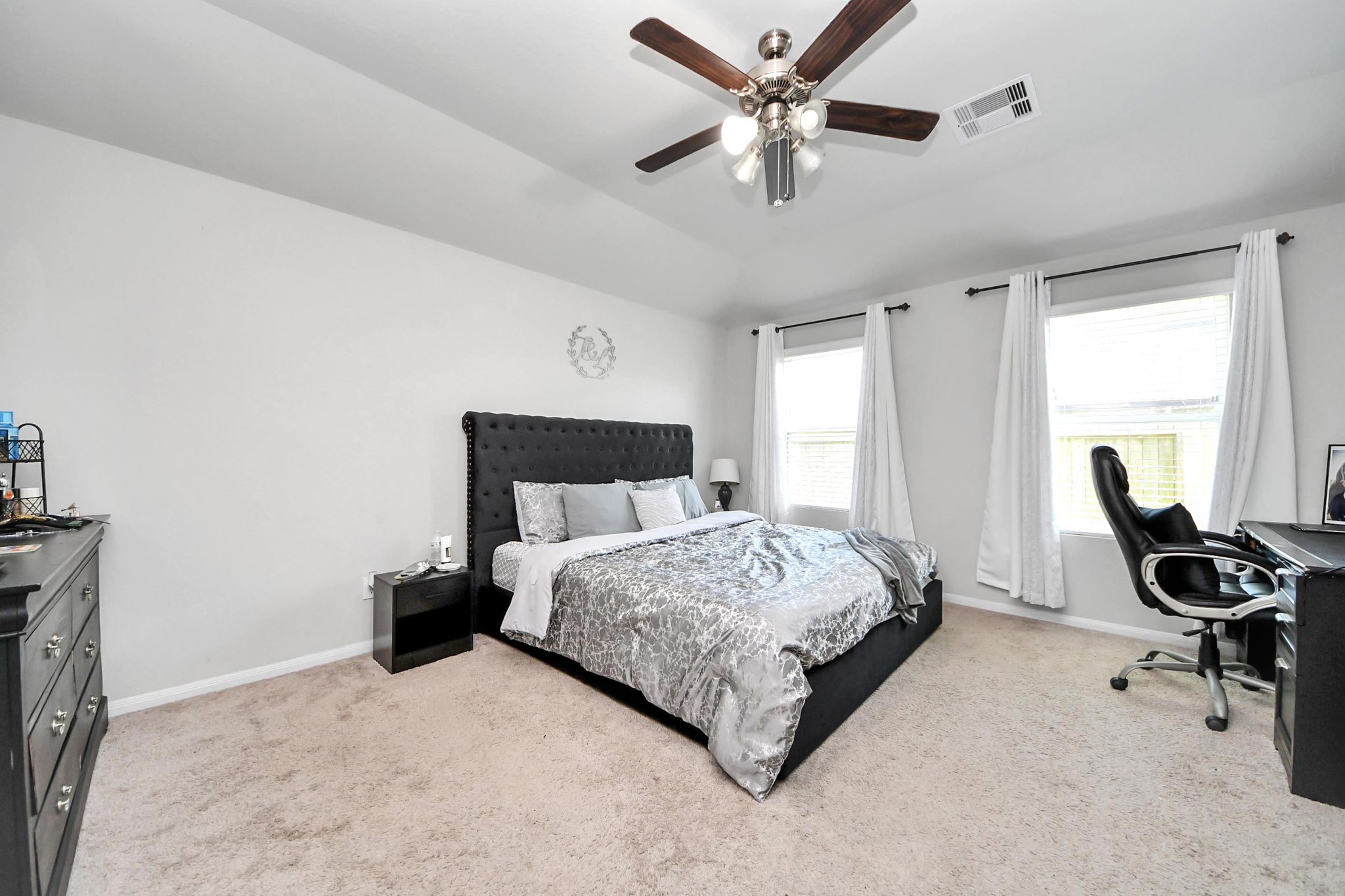 2643 Ridgeback Drive Rosenberg, TX 77471 - Photo 23 of 46 Spacious primary bedroom with large windows and neutral carpet.