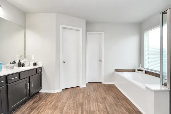 a bathroom with a double vanity sink and mirror