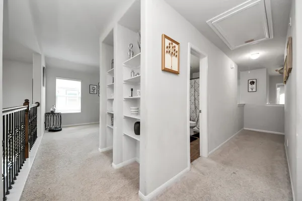 a view of a livingroom with furniture and a hallway