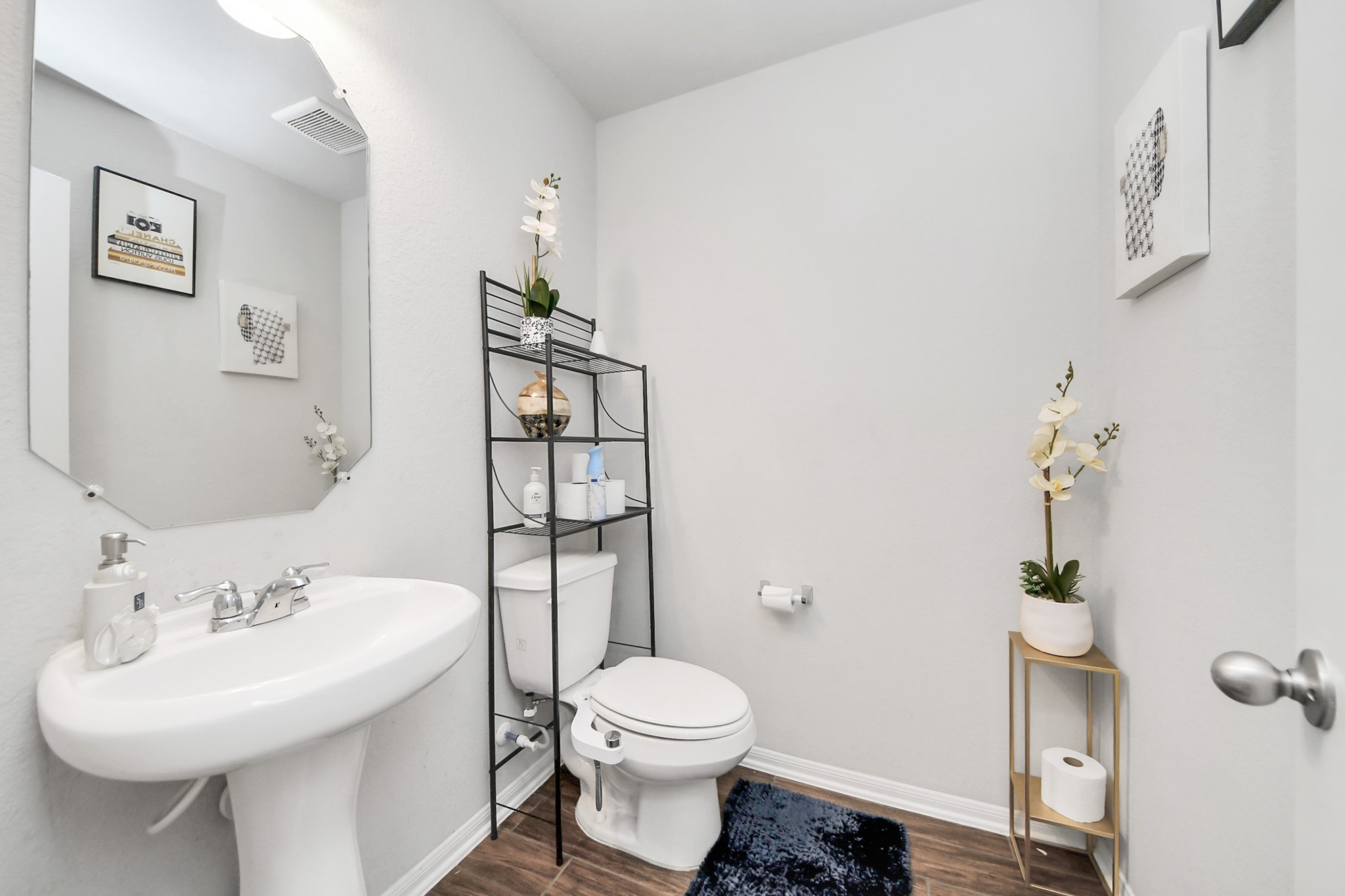 2643 Ridgeback Drive Rosenberg, TX 77471 - Photo 9 of 46 Convenient guest half bathroom located on the main floor, featuring a pedestal sink and updated lighting.