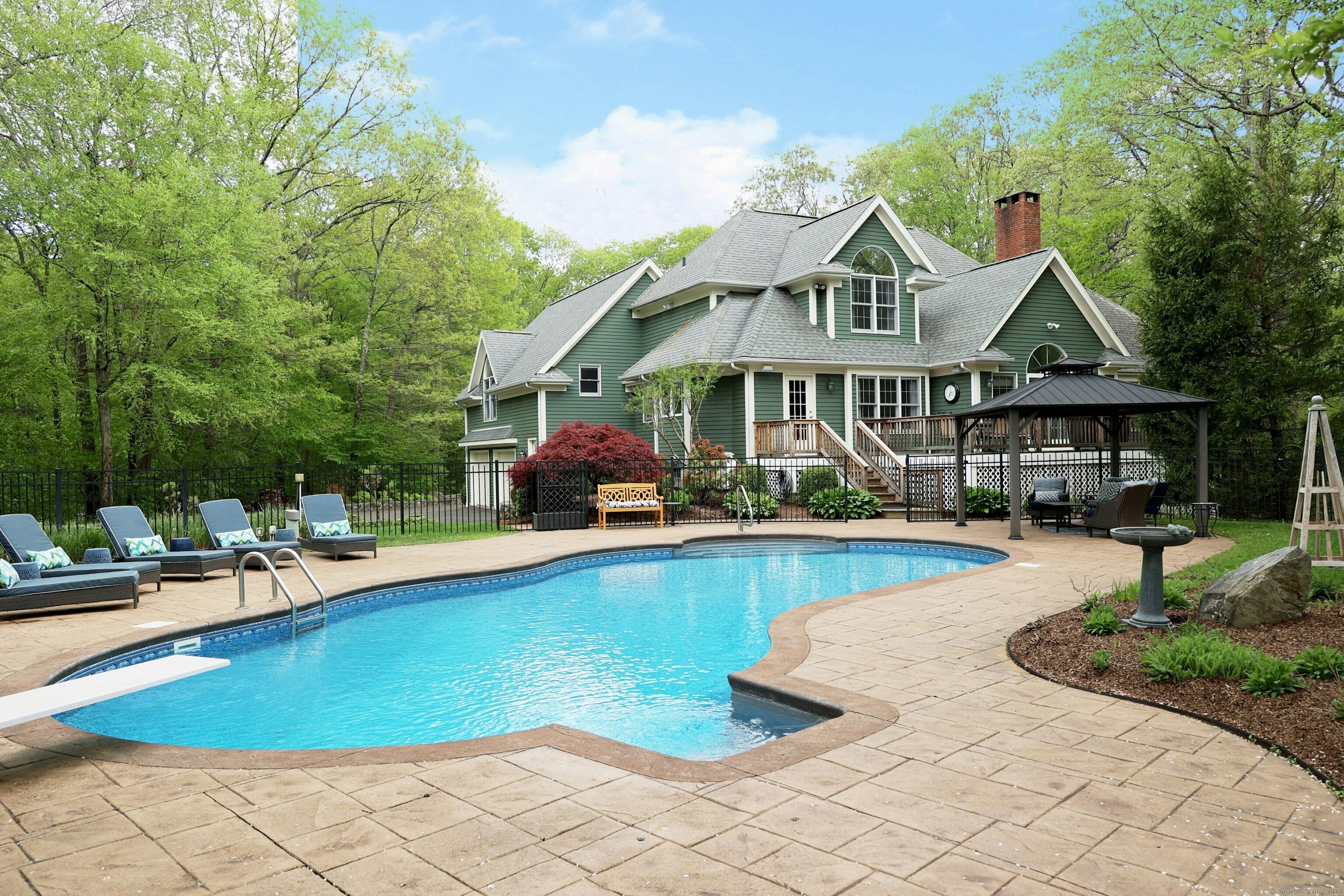 a view of a house with swimming pool and sitting area
