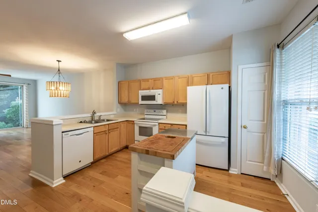 a kitchen with granite countertop a stove oven and a refrigerator