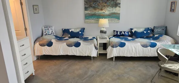 a spacious bedroom with bed and a window