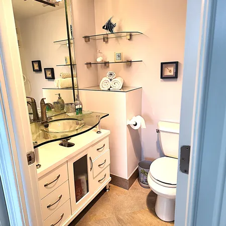 a bathroom with a sink a toilet and a mirror