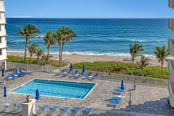 a view of a swimming pool with a lounge chair