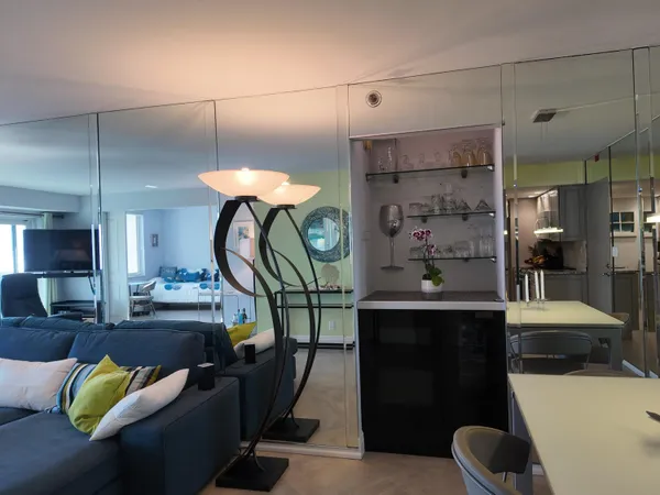 a living room with furniture and a chandelier