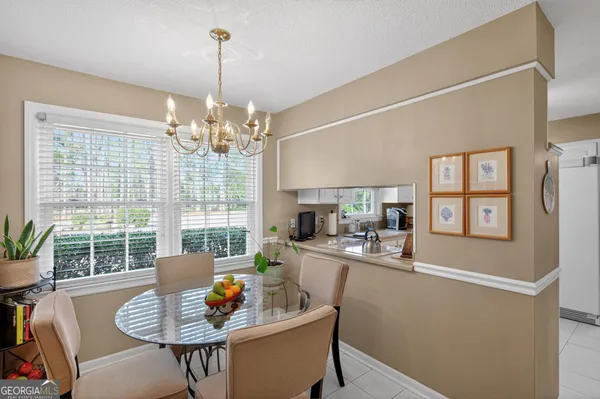 a dining room with furniture a chandelier and window