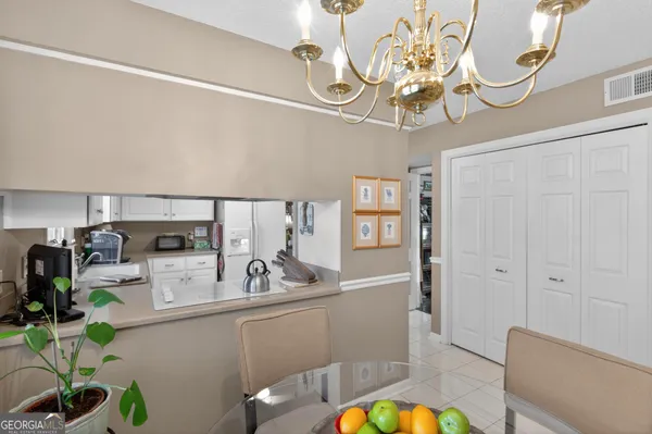 a kitchen with a sink cabinetry and chandelier