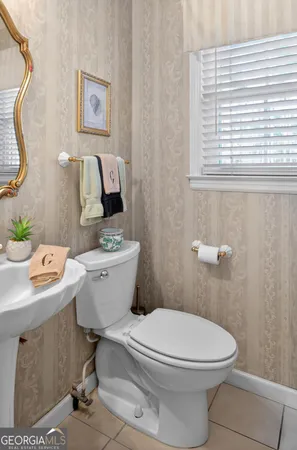 a bathroom with a toilet a sink and a window