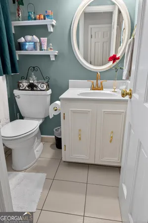 a bathroom with a toilet a sink and a mirror