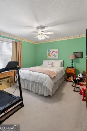 a bedroom with a bed and a mirror