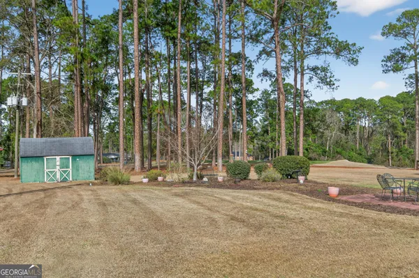 a backyard of a house with table and chairs