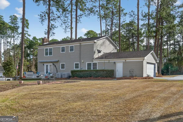 a front view of house with yard and trees
