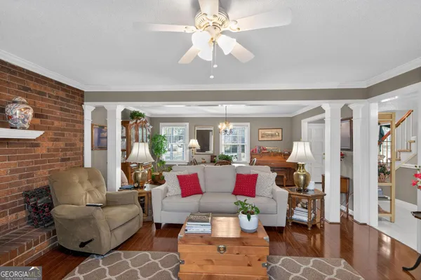 a living room with furniture and a chandelier