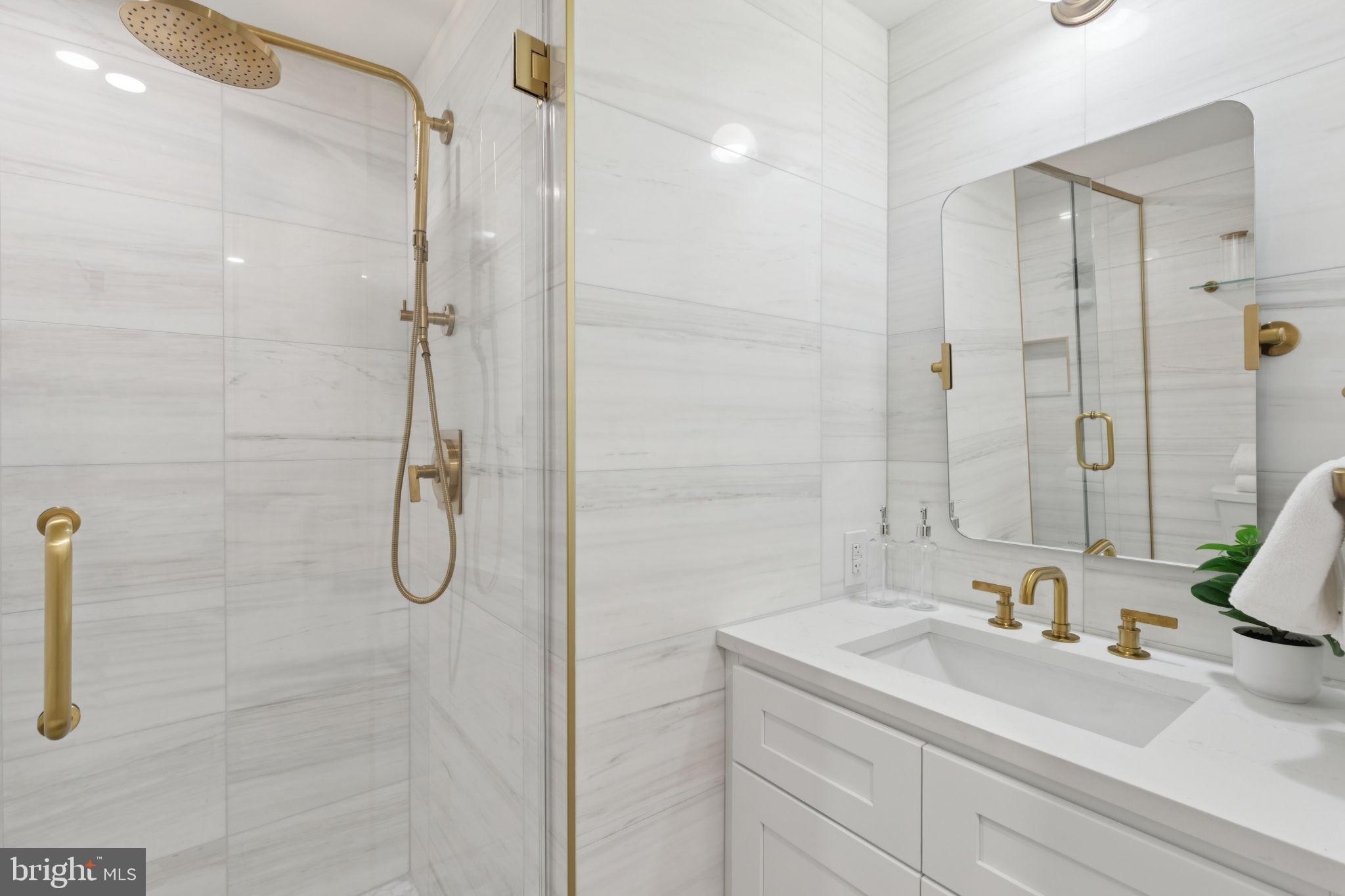 135 South 19th Street, Unit 403 Philadelphia, PA 19103 - Photo 11 of 19 a bathroom with a sink and a mirror