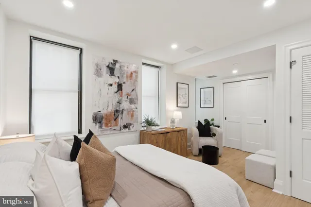 a large bedroom with a bed and a table