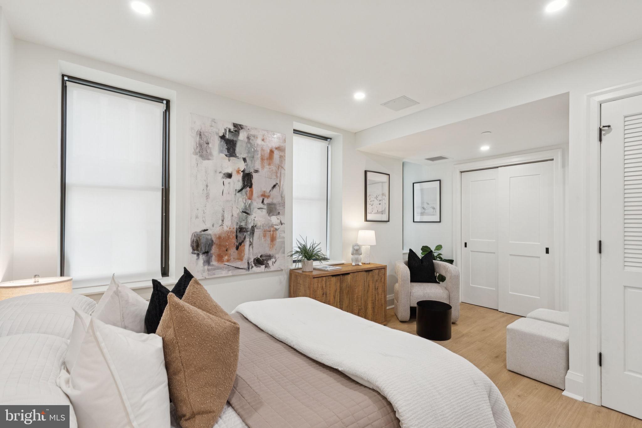 135 South 19th Street, Unit 403 Philadelphia, PA 19103 - Photo 3 of 19 a large bedroom with a bed and a table