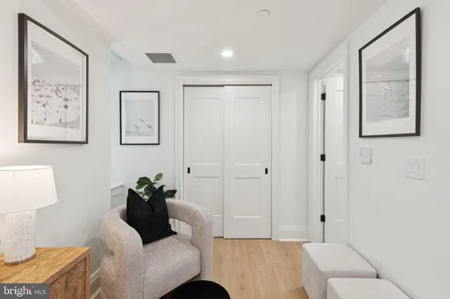 a living room with furniture and a lamp