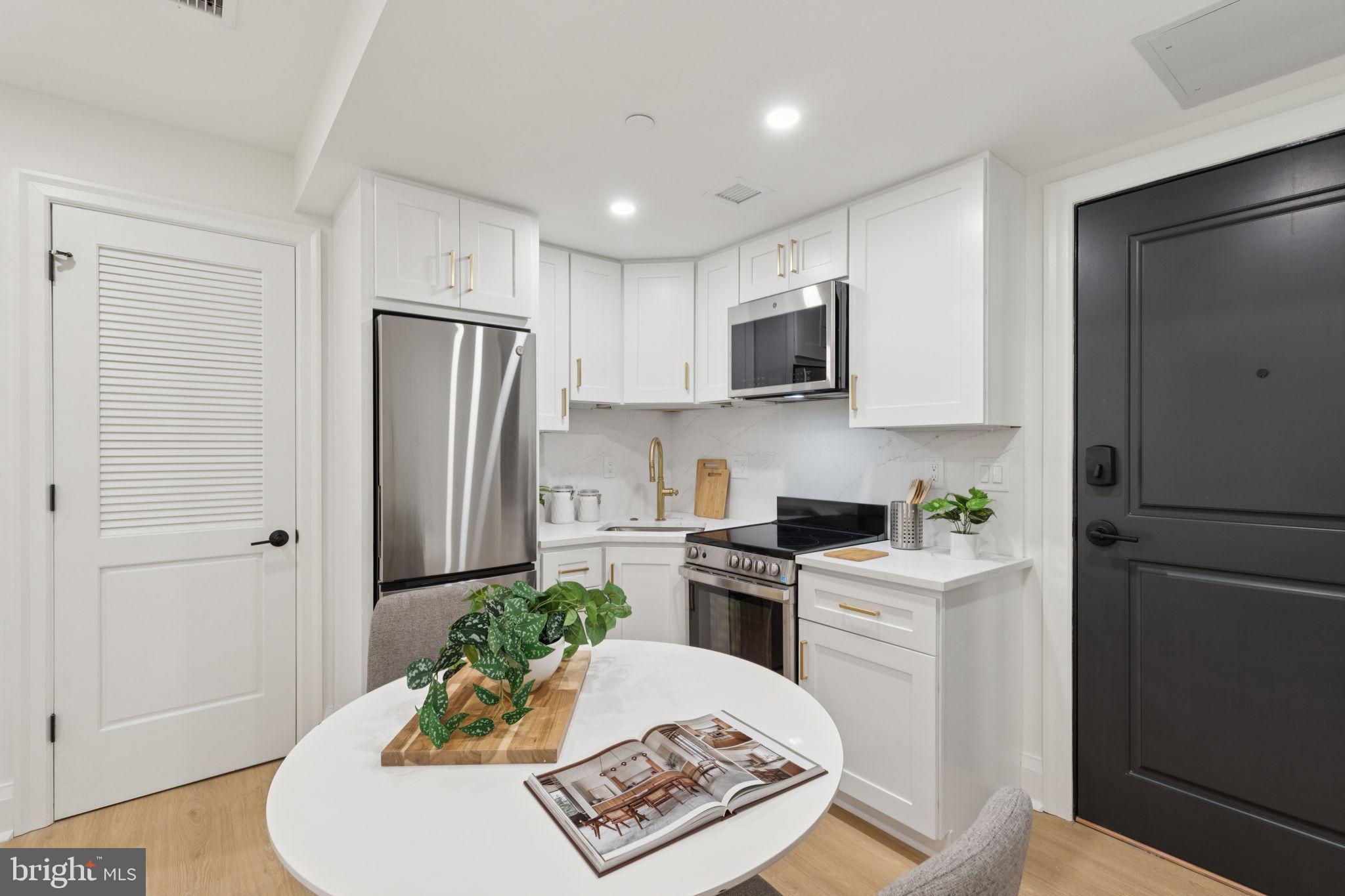 135 South 19th Street, Unit 403 Philadelphia, PA 19103 - Photo 6 of 19 a kitchen with stainless steel appliances granite countertop a refrigerator sink and stove