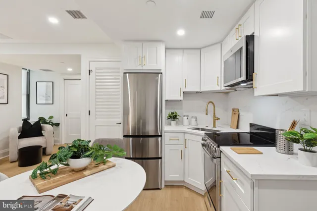 a kitchen with refrigerator and cabinets
