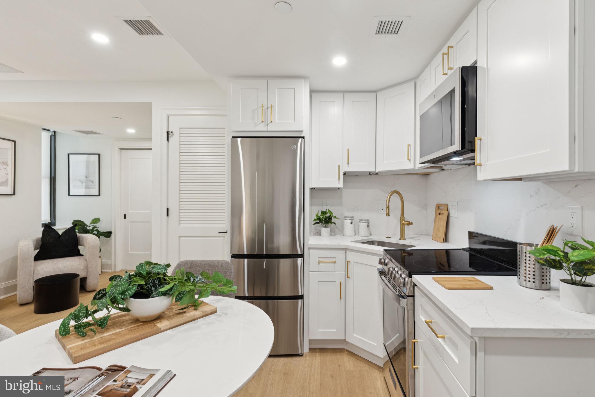 135 South 19th Street, Unit 403 Philadelphia, PA 19103 - Photo 9 of 19 a kitchen with refrigerator and cabinets