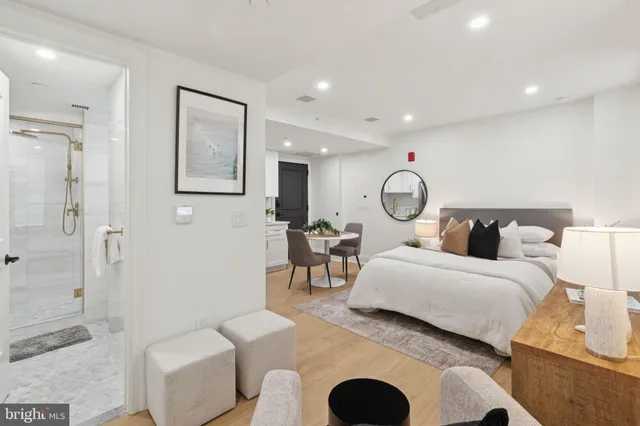 a bedroom with bed and a chandelier