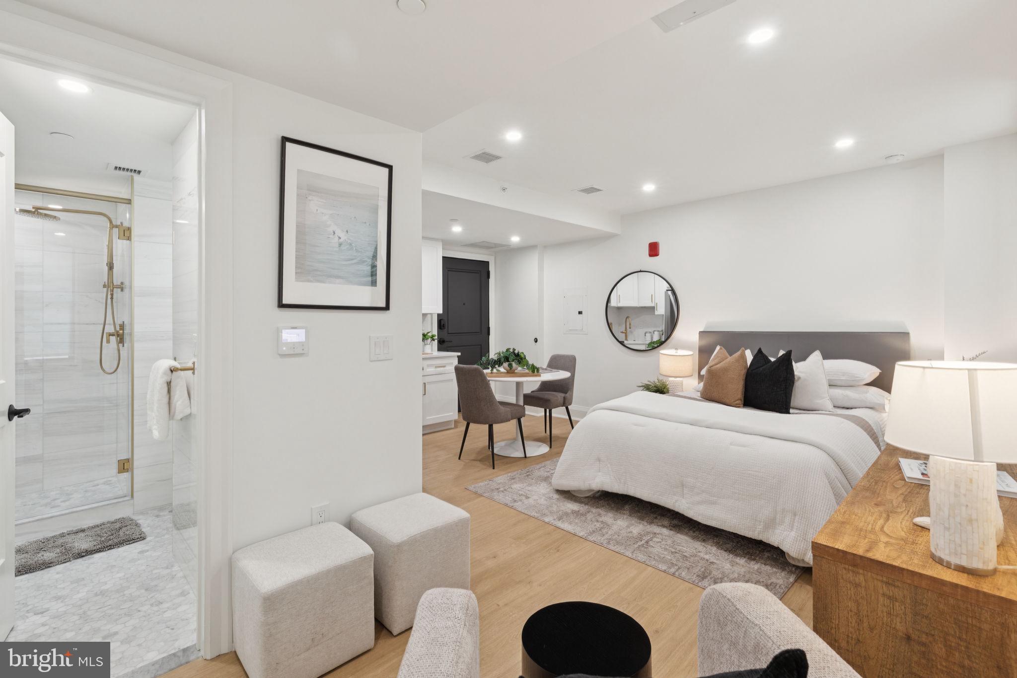 135 South 19th Street, Unit 403 Philadelphia, PA 19103 - Photo 10 of 19 a bedroom with bed and a chandelier