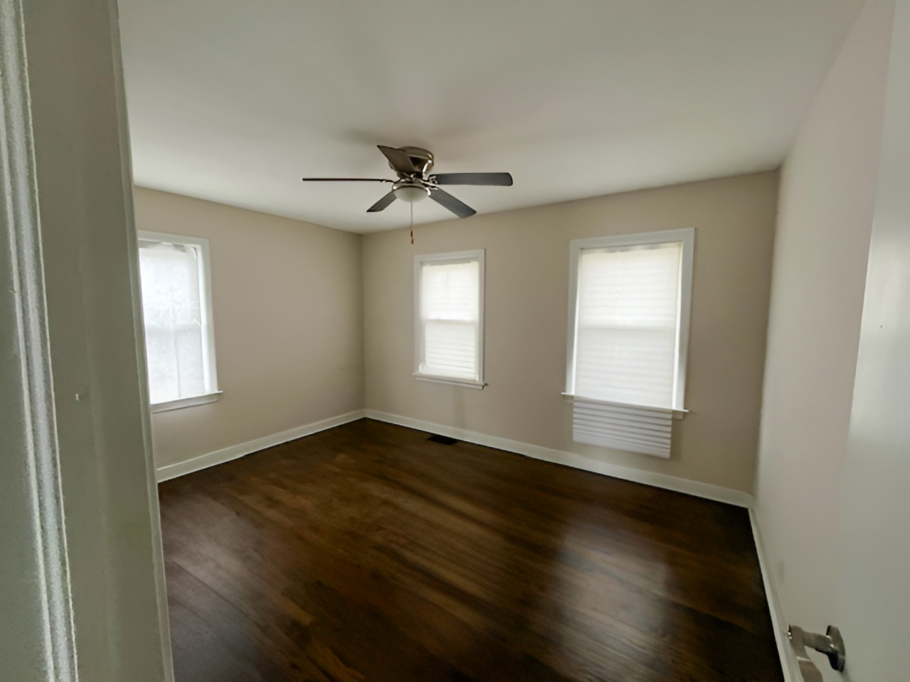 17943 Ridgewood Avenue Lansing, IL 60438 - Photo 5 of 12 a view of an empty room with wooden floor and a window