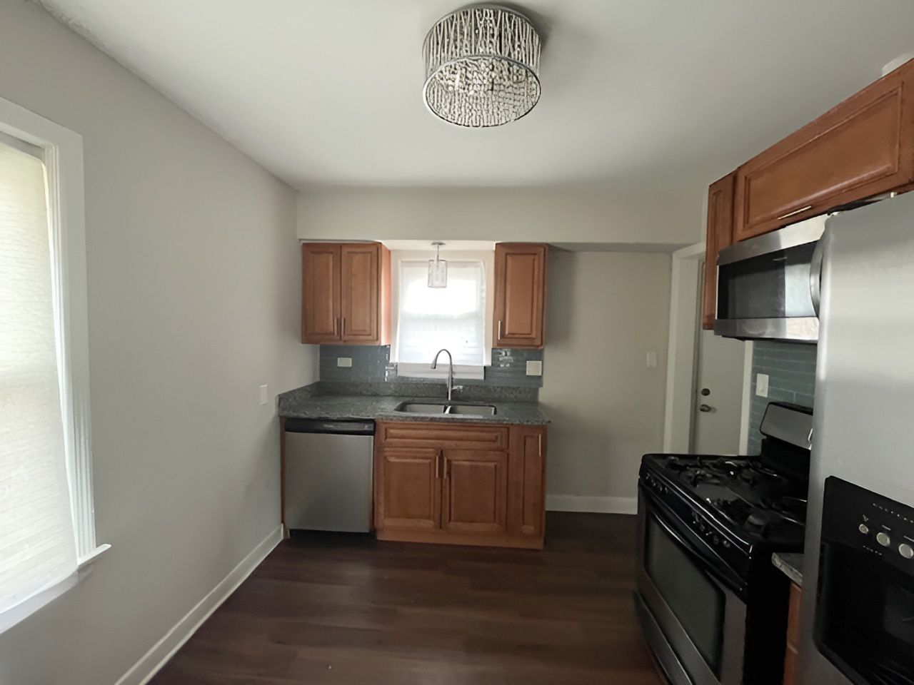 17943 Ridgewood Avenue Lansing, IL 60438 - Photo 7 of 12 a kitchen with stainless steel appliances granite countertop a sink and a stove top oven
