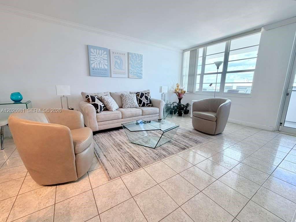 100 Lincoln Road, Unit 1423 Miami Beach, FL 33139 - Photo 4 of 17 a living room with furniture and a window