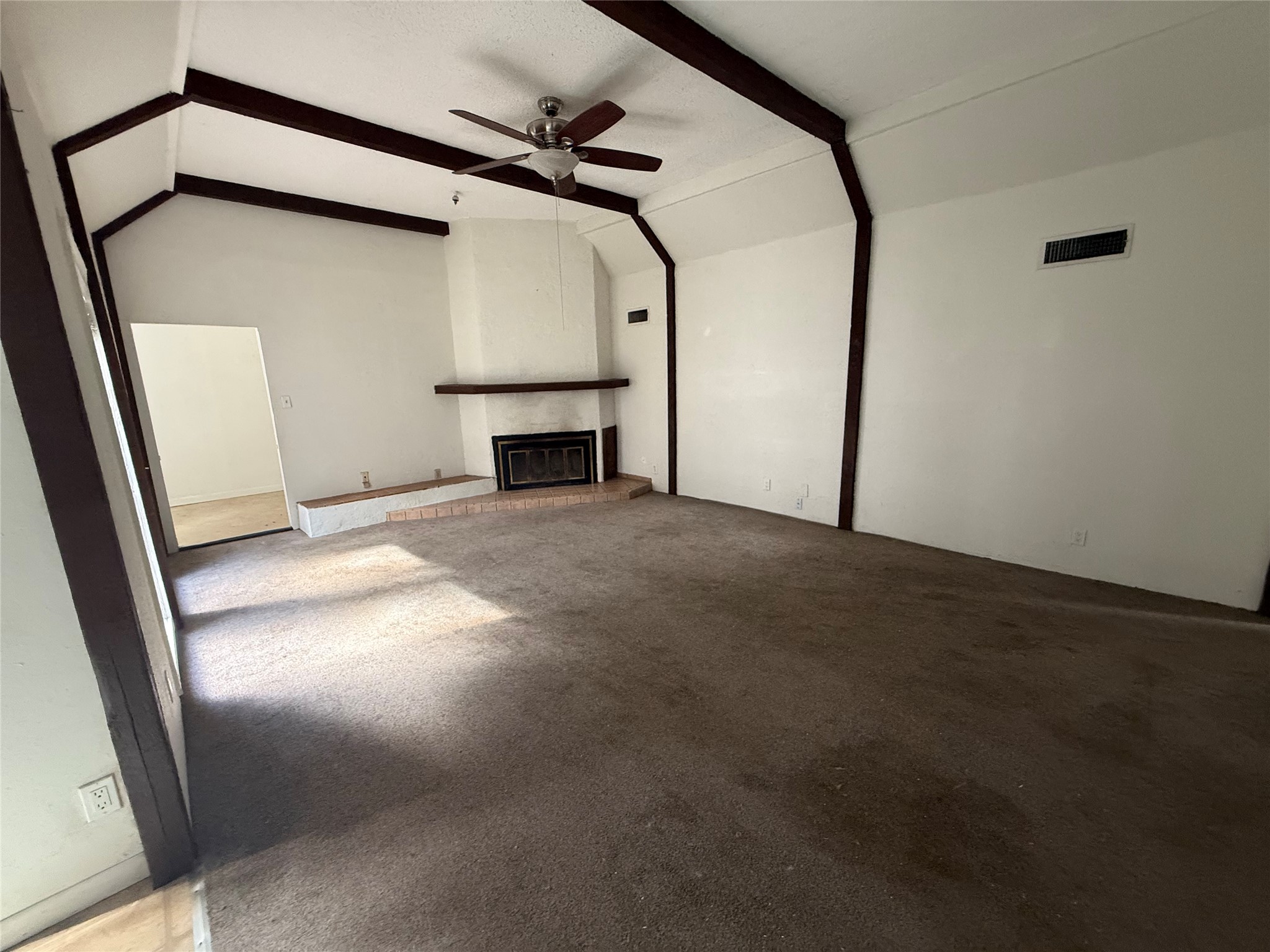 254 Lone Star Road Bastrop, TX 78602 - Photo 5 of 20 A spacious living room with vaulted ceilings and a wood burning fireplace.