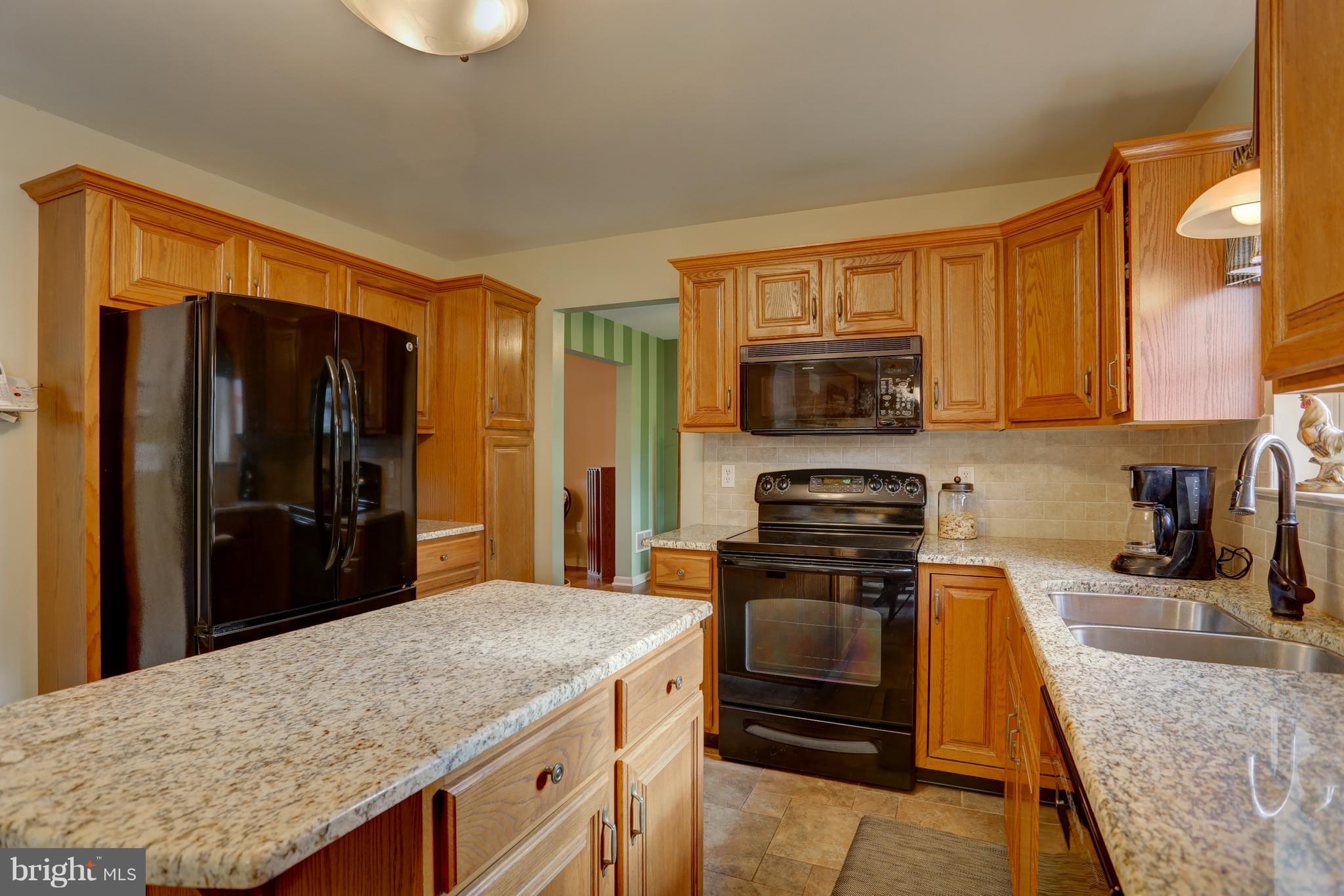 12 Foxrun Terrace Lititz, PA 17543 - Photo 14 of 42 a kitchen with stainless steel appliances granite countertop a stove refrigerator and microwave