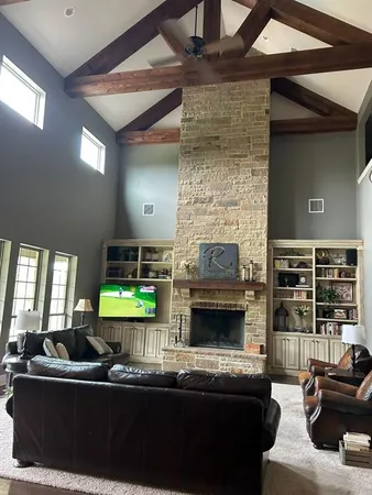 a living room with fireplace furniture and a fireplace